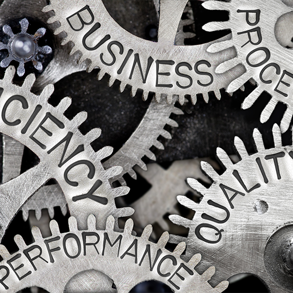 Interlocking metal gears labeled quality, efficiency and performance